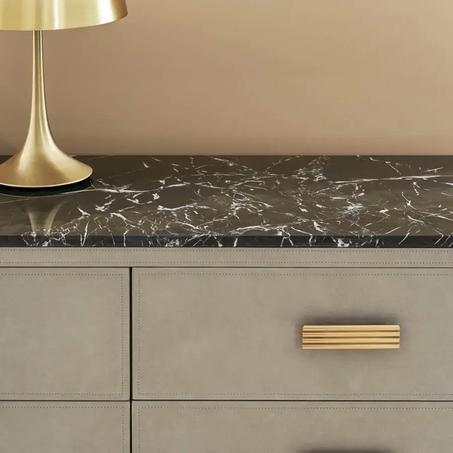 Lavish Rugiano Rubik dresser with gray leather upholstery, visible stitchings and a black marble top