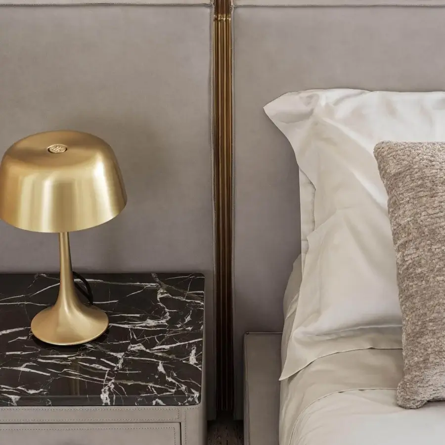 Superior Rugiano Rubik bed fully padded in light gray textile with elegant golden metal details flanking the headboard