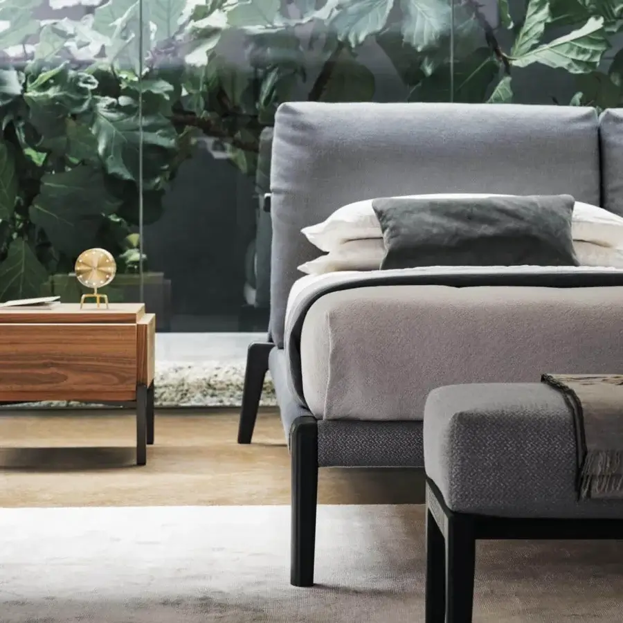 Exceptional Bonaldo Kriss bed with textured gray textile upholstery and dark wooden legs creating a warm look