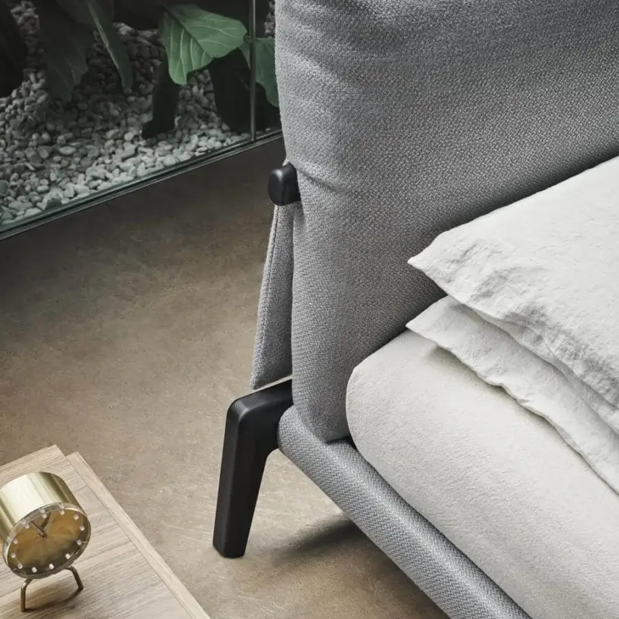 Distinguished Bonaldo Kriss bed with soft gray textile upholstery, a curved headboard and angular dark wooden legs