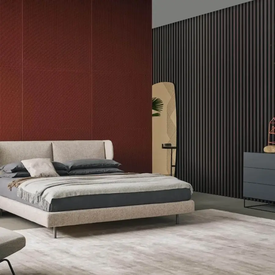 Elegant Bonaldo River bed with light beige textured upholstery and slender metal legs creates a welcoming centerpiece