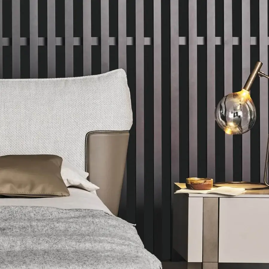 Sophisticated Bonaldo Blend bed with textured white fabric upholstery and smooth tan emery leather inserts, built with painted metal feet