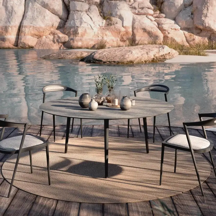 Distinguished Royal Botania Styletto chair with compelling curves and a dark matte aluminum frame paired with light textile cushioning