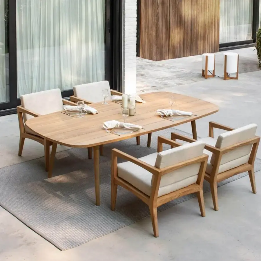 Exceptional Royal Botania Styletto table with cylindrical teak wood legs and smooth teak wood tabletop exhibiting rounded corners