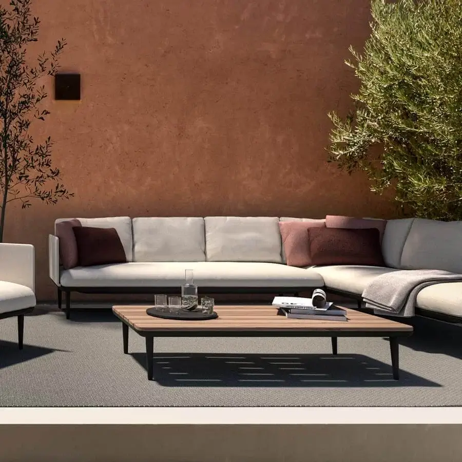 Sophisticated Royal Botania Styletto lounge coffee table with dark metal frame and sustainable teak wood top