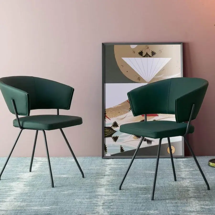Exceptional Bonaldo Bahia armchair with dark green upholstery and slender black metal legs offering a contemporary design
