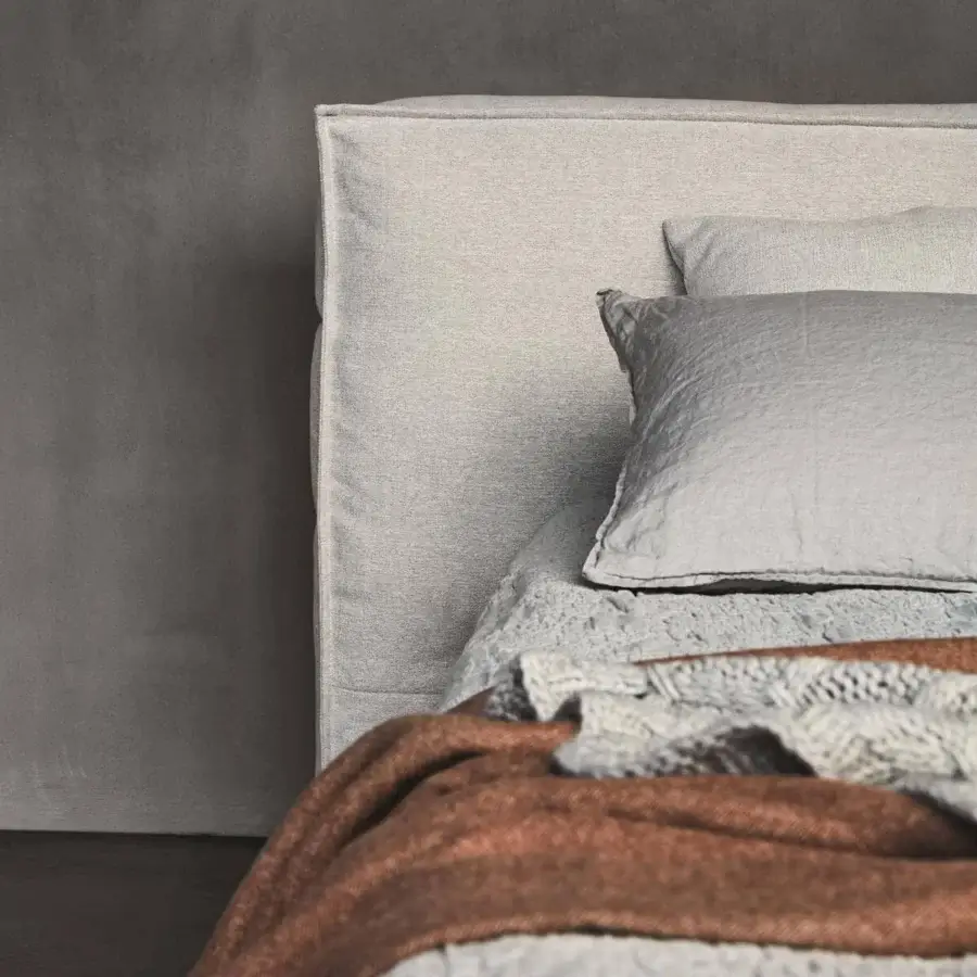 Sophisticated Ditre Italia Flann bed with padded headboard and base in light-colored removable fabric upholstery