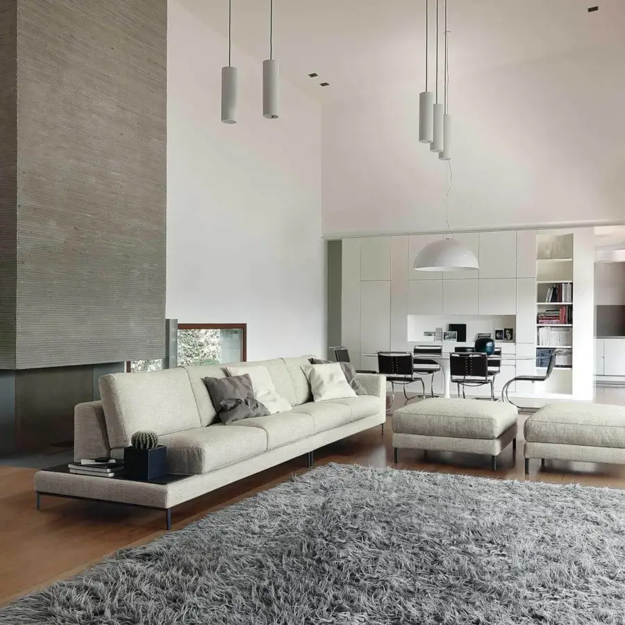 Exclusive Ditre Italia Artis sofa with light beige fabric upholstery and dark finished L-shaped metal legs displaying “Punto Pettine” stitching
