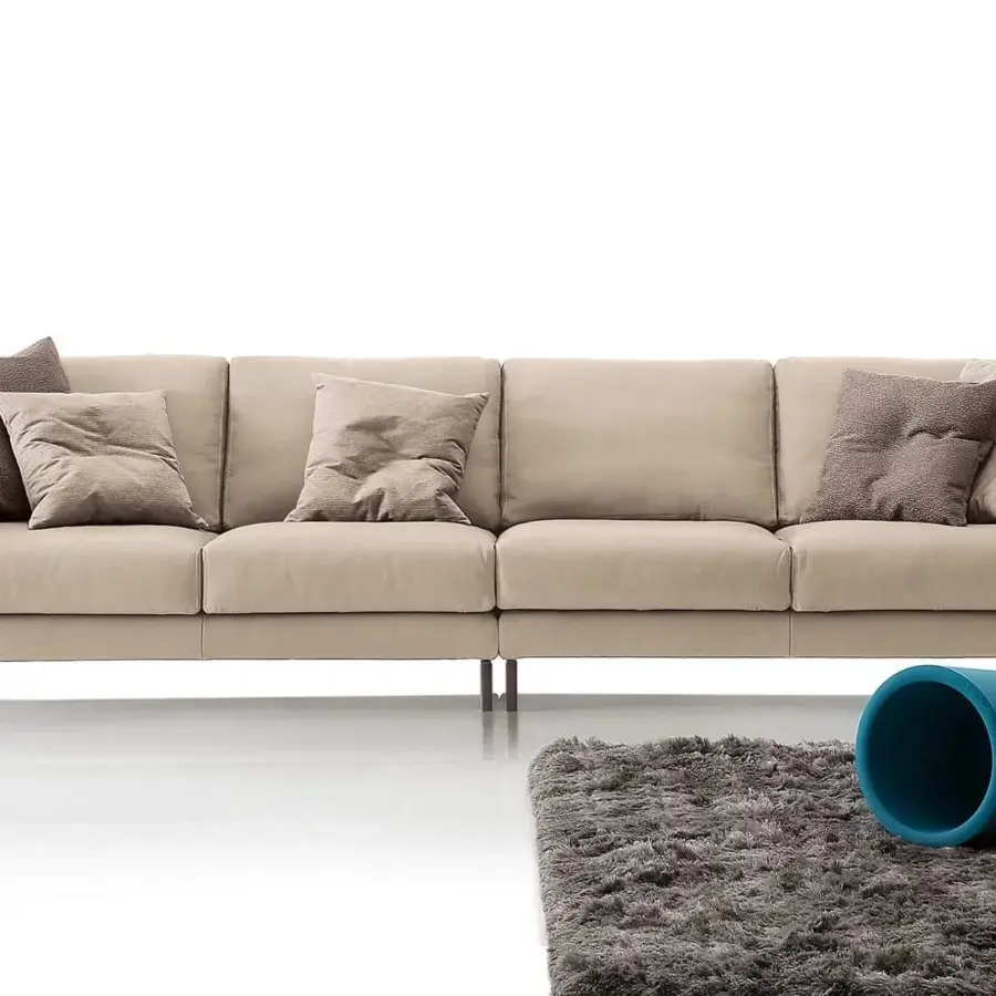 Elegant Ditre Italia Artis sofa with light beige fabric upholstery and “Punto Pettine” stitching with dark legs