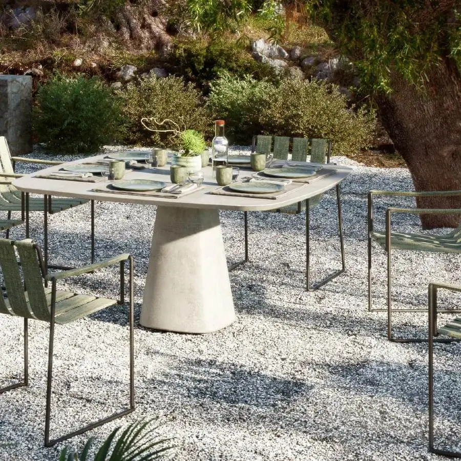 Distinguished Royal Botania Conix table with a round concrete tabletop and conical base in a matte light grey finish