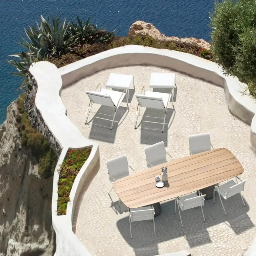 Distinguished Royal Botania Conix table with light-toned fibre-reinforced concrete bases and a light brown teak wood top crafted with visible grain