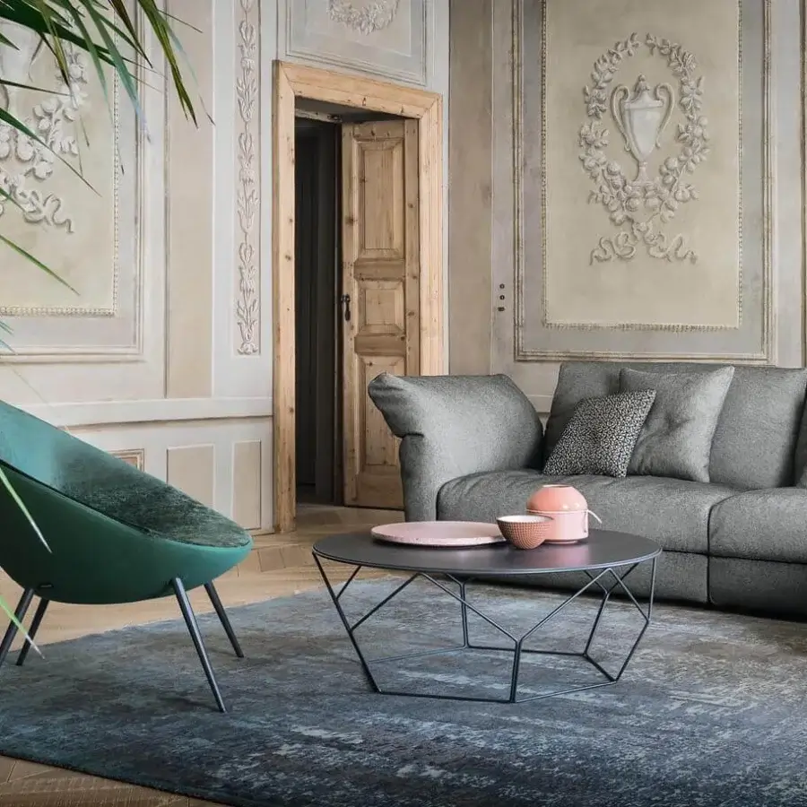 Elegant Bonaldo Arbor coffee table with curved dark metal rods supporting a thin round top and matte finish