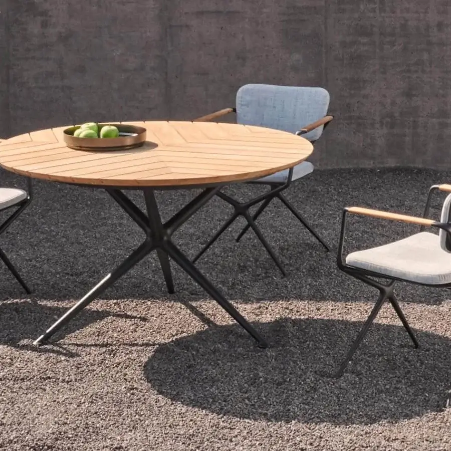 Distinguished Royal Botania Exes table with teak wood tabletop and coated aluminum star-like base showcasing a smooth radial finish