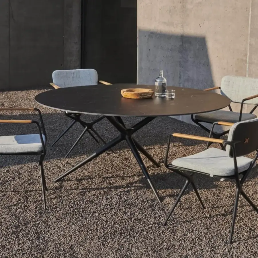Distinguished Royal Botania Exes table with dark ceramic top and coated aluminum base showcasing a geometric matte finish