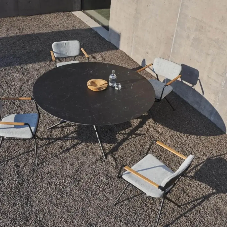 Superior Royal Botania Exes table with dark marble-like ceramic top and intersecting coated aluminum legs in matte finish