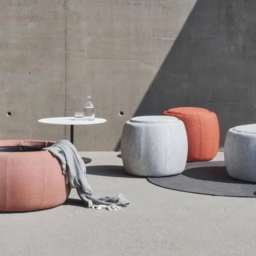 Elegant Royal Botania Tono ottoman in light pink textile with matte finish reveals storage crafted from molded plastic