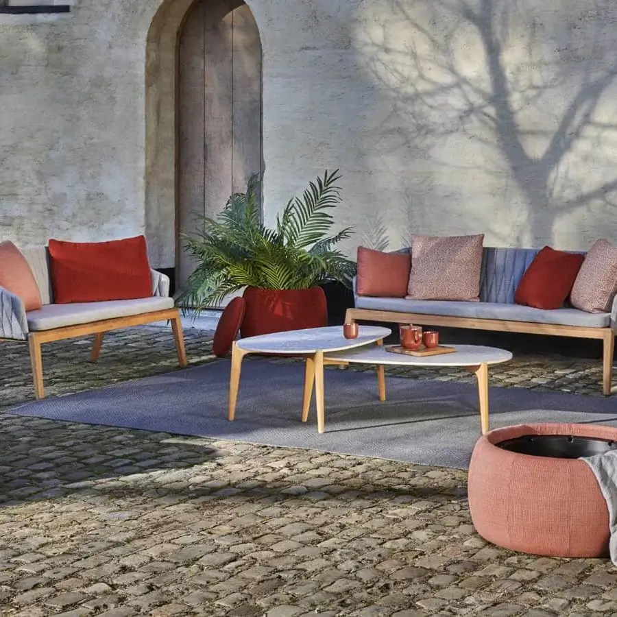Distinguished Royal Botania Calypso Lounge ottoman built with teak and woven upholstery in a muted coral hue