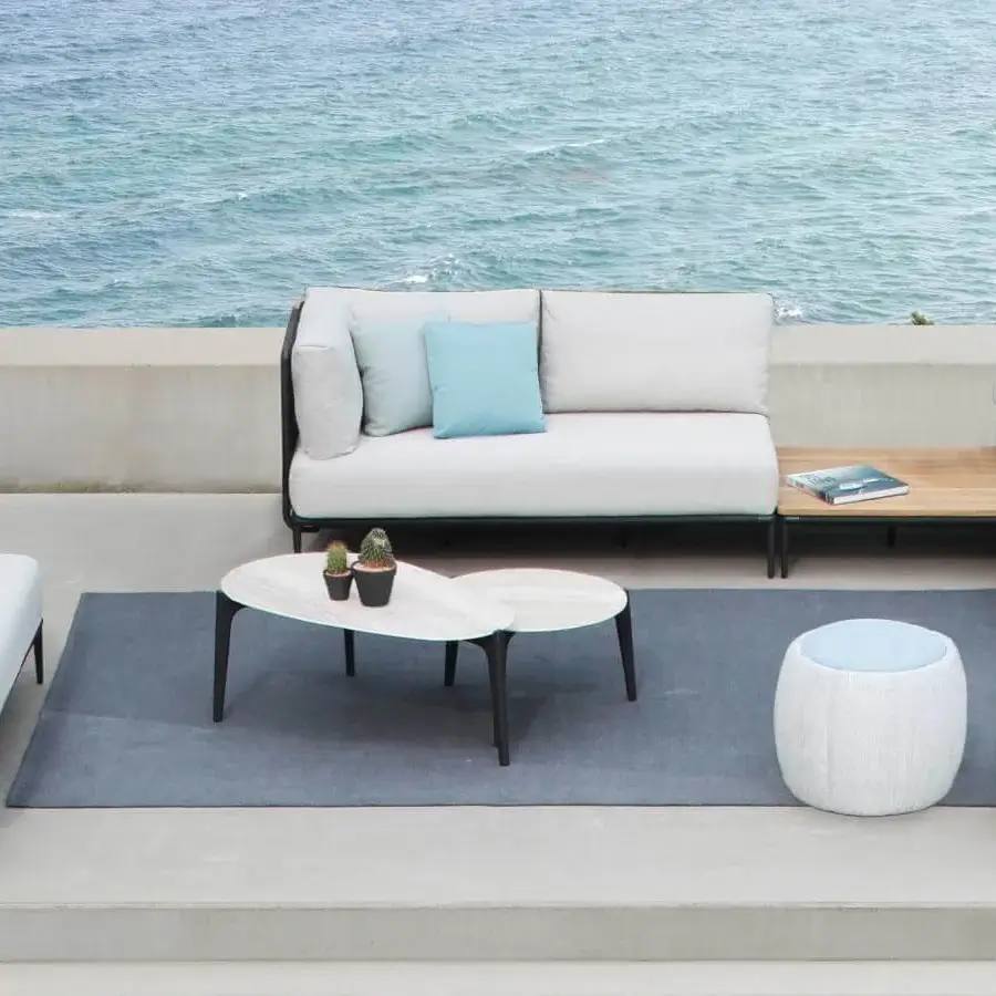 Exclusive Royal Botania Tono ottoman with molded plastic core and light blue zippered textile exhibiting a textured finish