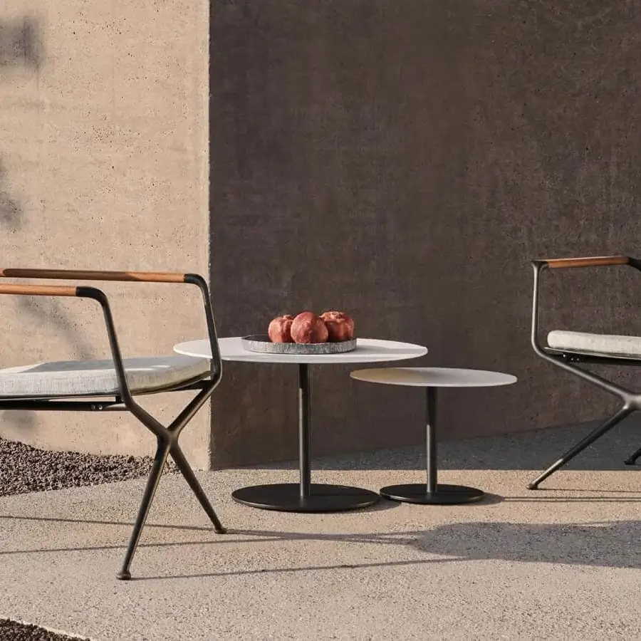 Distinguished Royal Botania Butler side table with circular white top and sleek black coated stainless steel base in contrasting matte finishes