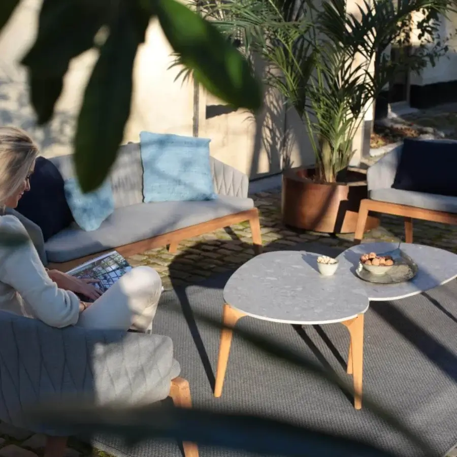 Distinguished Royal Botania Calypso lounge chair with refined teak base and textured light gray textile upholstery, stainless steel backrest