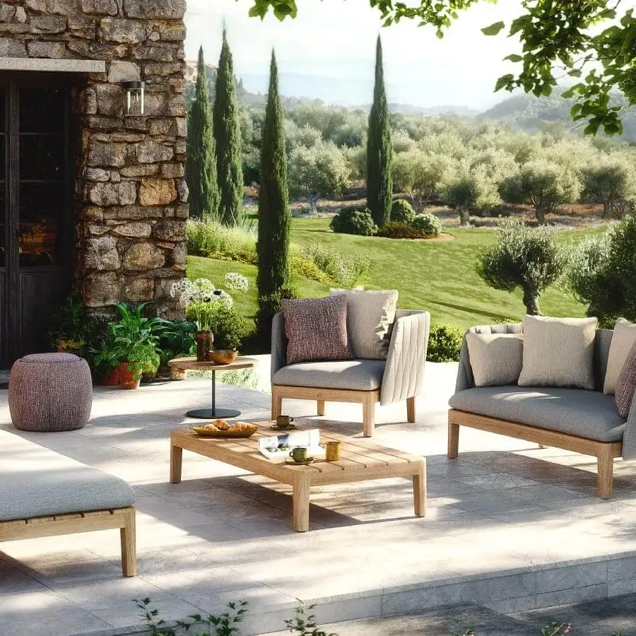Superior Royal Botania Calypso lounge chair with light-toned teak base, stainless steel backrest and plush gray textile upholstery