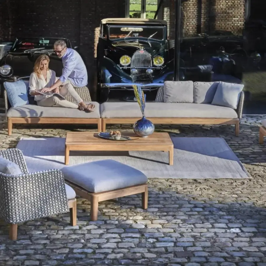 Distinguished Royal Botania Calypso lounge lounger with reclining teak base, light gray cushions and stainless steel backrest with blue accent