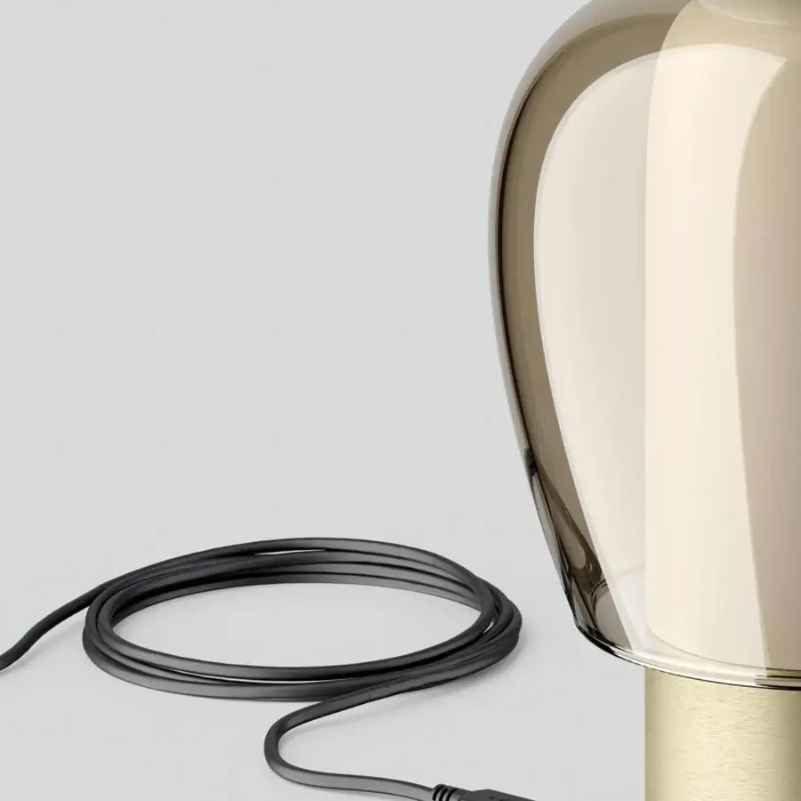 Superior Lodes Easy Peasy table lamp with a sculptural form in translucent smoky brown and bright turquoise blown glass with a light gold brushed metal base