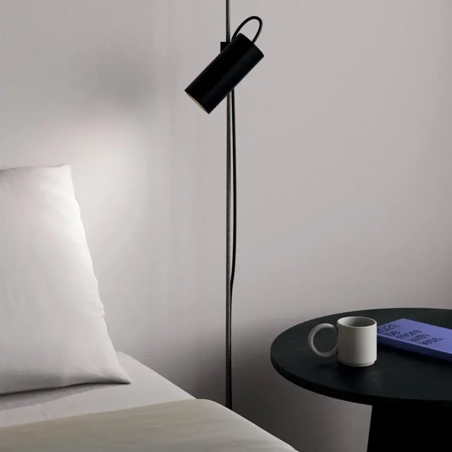 Superior Lodes Cima floor lamp with a cylindrical head suspended by a vibrant black rope and matte black metal structure