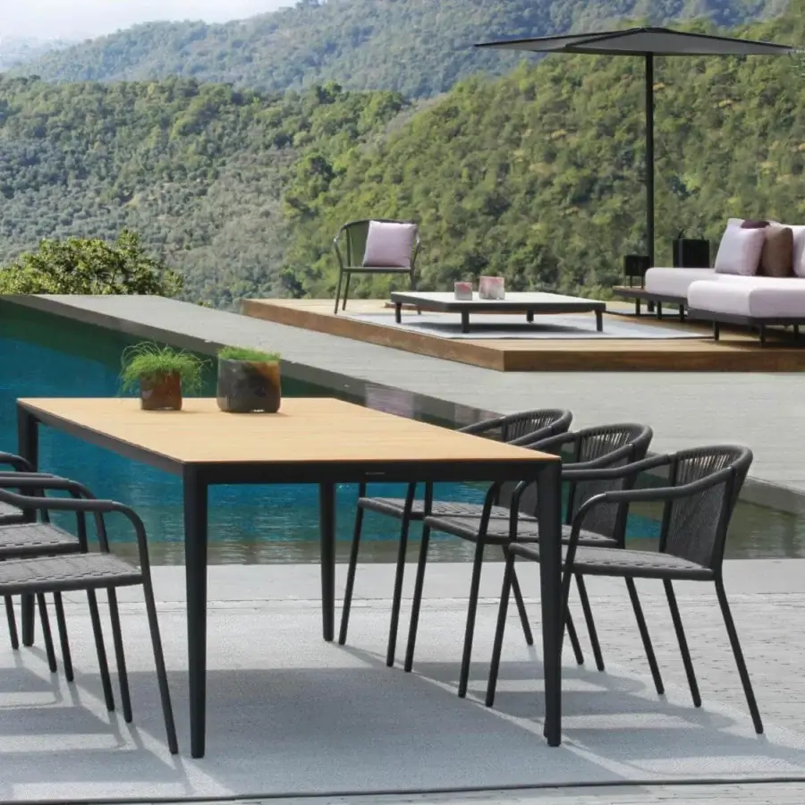 Superior Royal Botania U-nite table crafted with teak and dark metal in a smooth, light-toned wood-like finish