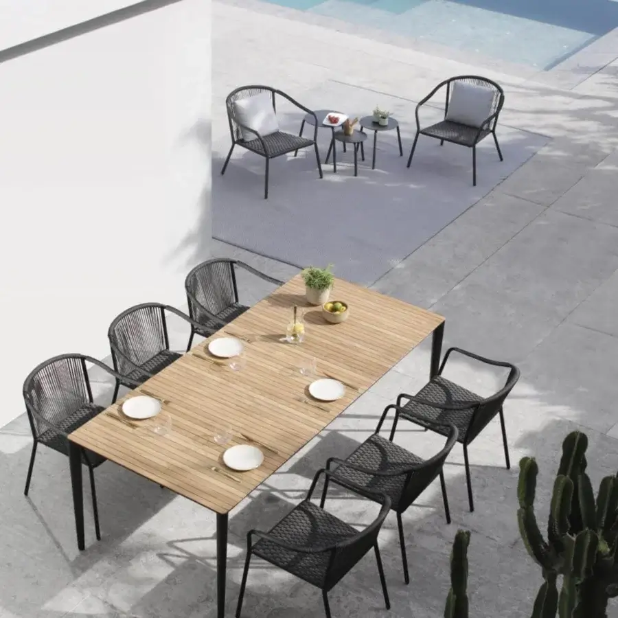 Elegant Royal Botania U-nite table crafted with light teak and dark metal exhibiting a smooth matte finish