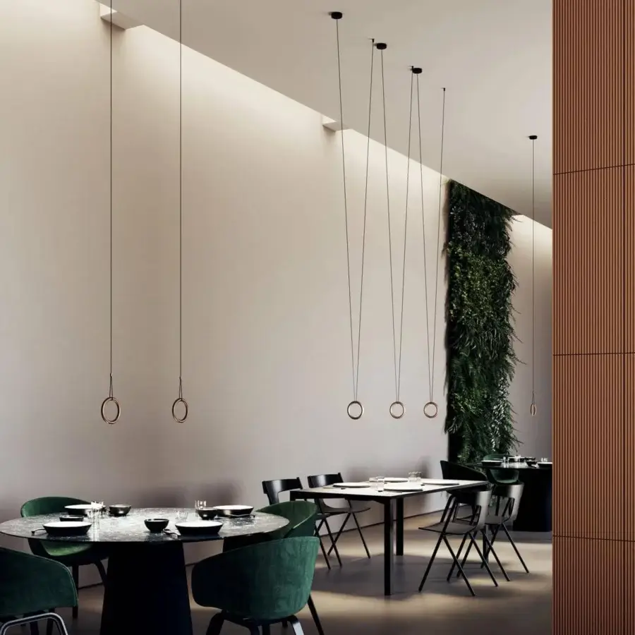 Distinguished Lodes IVY V suspension lamp crafted in bronze or copper with a sleek geometric ring and black cords