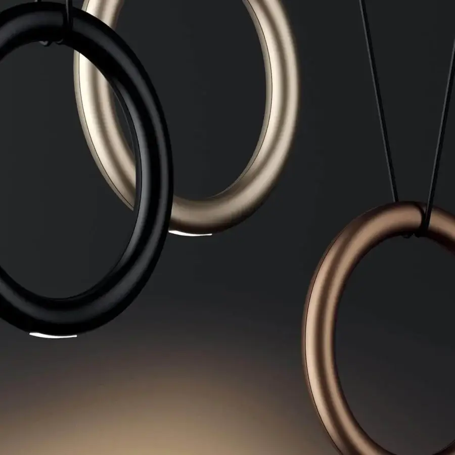 Distinguished Lodes IVY V suspension lamp with a minimalist metal ring and glossy champagne finish emitting a soft directed glow