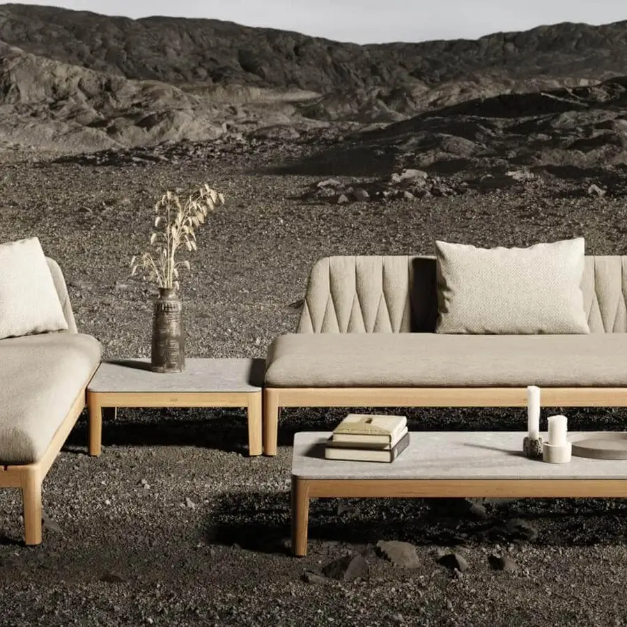 Distinguished Royal Botania Calypso sectional with teak base and stainless steel U-shaped backrests, complemented by sumptuously comfortable taupe textile cushions