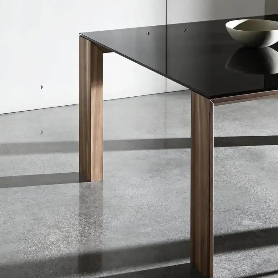 Captivating Sovet Italia Toronto table with reflective black tempered glass and Wengè-stained oak legs crafted in a "V" profile