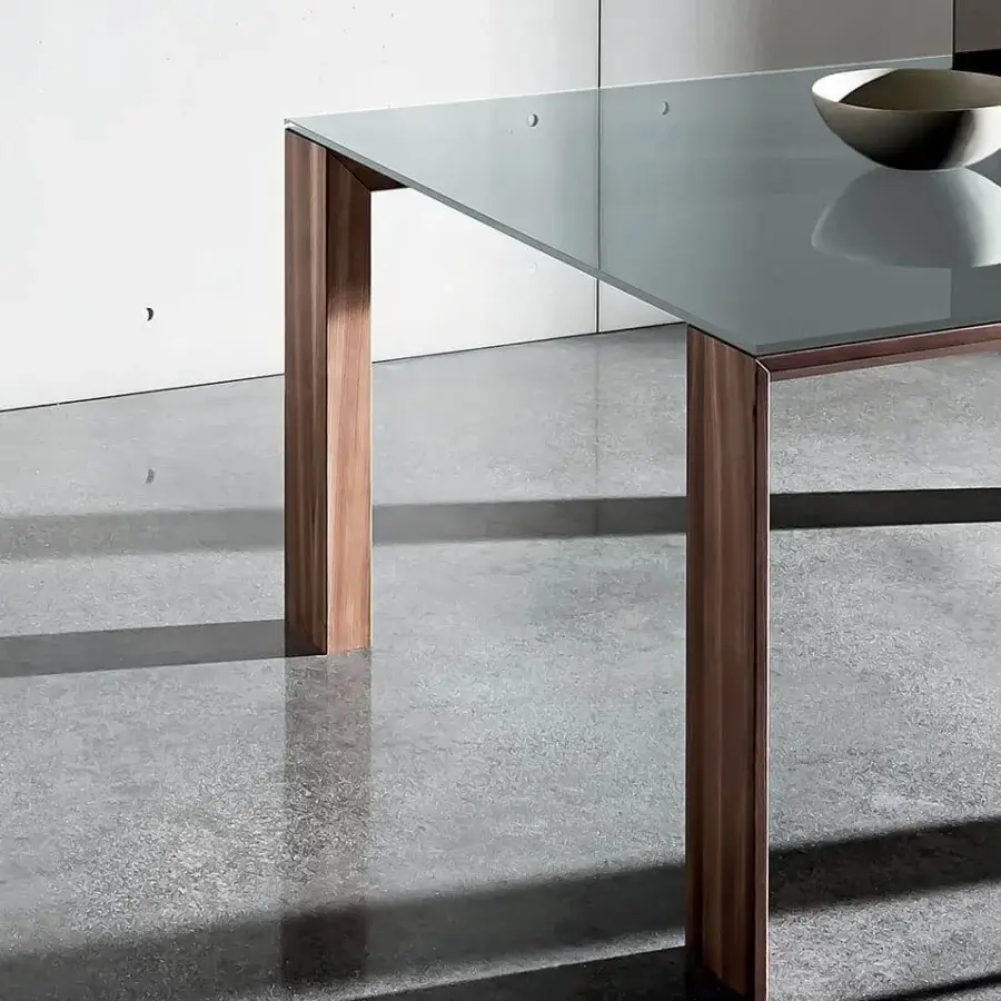 Elegant Sovet Italia Toronto table with transparent glass showcasing a Wengè-stained oak frame and distinctive V-profile legs