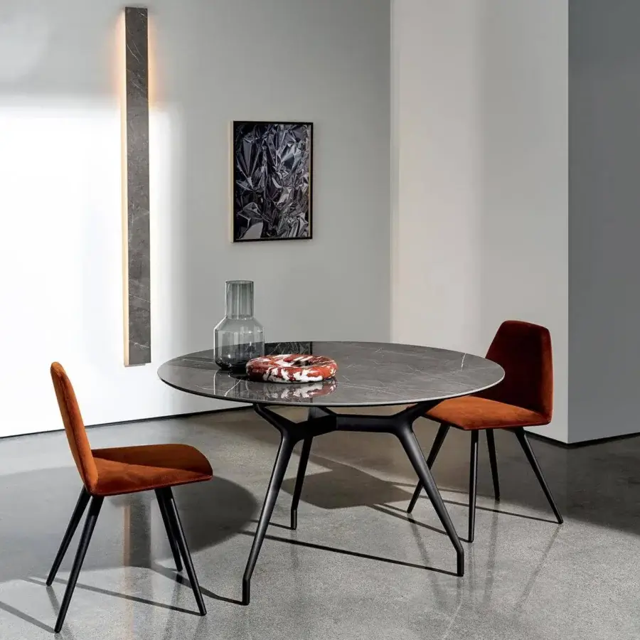 Superior Sovet Italia Arkos table with smooth gray stone-look tabletop and sleek black die-cast aluminum legs in an X formation