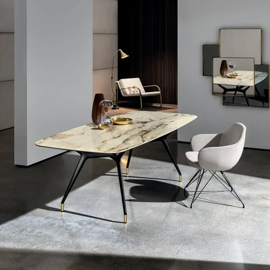 Refined Sovet Italia Arkos table with a marbled cream, beige, and brown top and matte black structural X legs