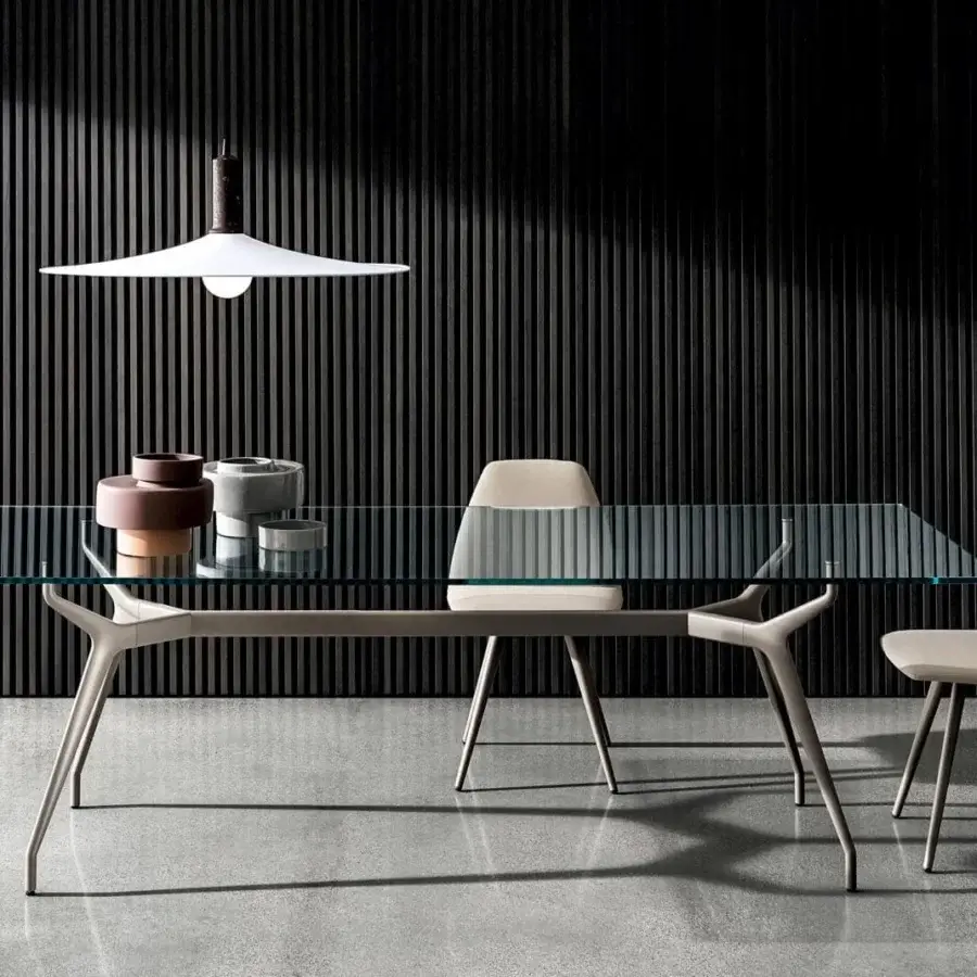 Cutting-edge Sovet Italia Arkos table with a sleek glass top and matte gray die-cast aluminum X-shaped legs