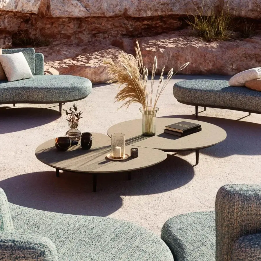 Exceptional Royal Botania Organix lounge table with shaped aluminum base and curved ceramic top in light brown matte finish