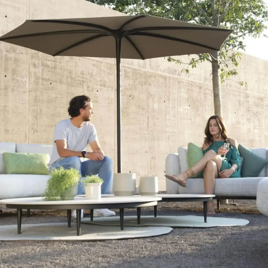 Sophisticated Royal Botania Organix lounge table with tapered aluminum legs and curved ceramic top