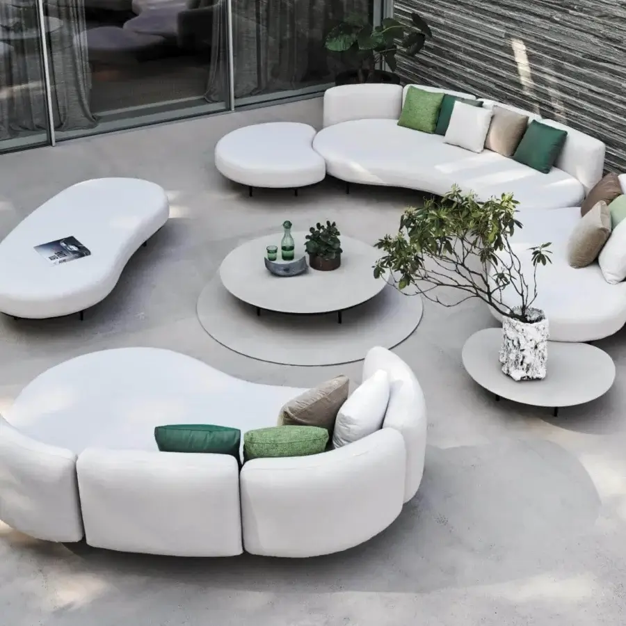 Distinguished Royal Botania Organix lounge coffee table with shaped aluminum base and curved white ceramic top in smooth matte finish