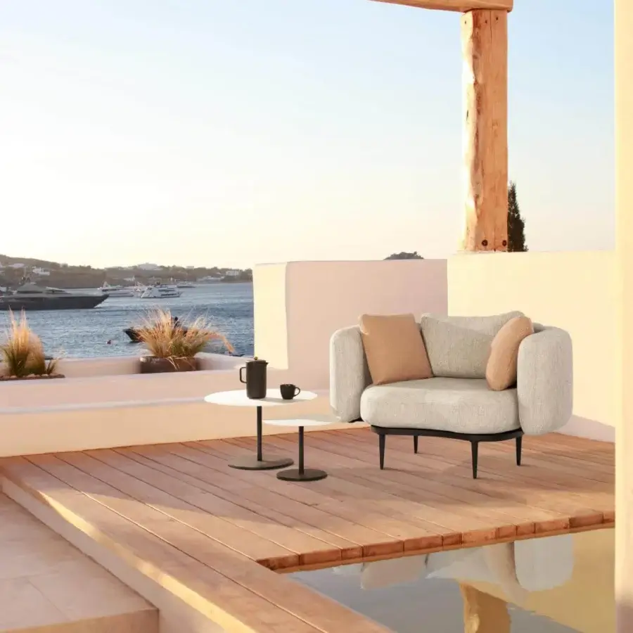 Refined Royal Botania Organix lounge chair with light gray textured seat, tan cushions and dark-toned aluminum base