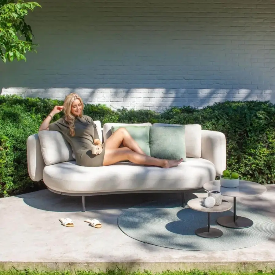 Superior Royal Botania Organix Lounge sofa with kidney-shaped seat, curved backrest cushions and sleek aluminum base in light beige textile with muted green accents