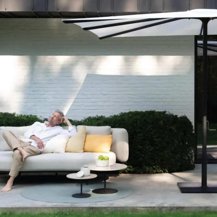 Elegant Royal Botania Bloom sofa with smooth lines, neutral textile, and cream yellow cushions in matte finish