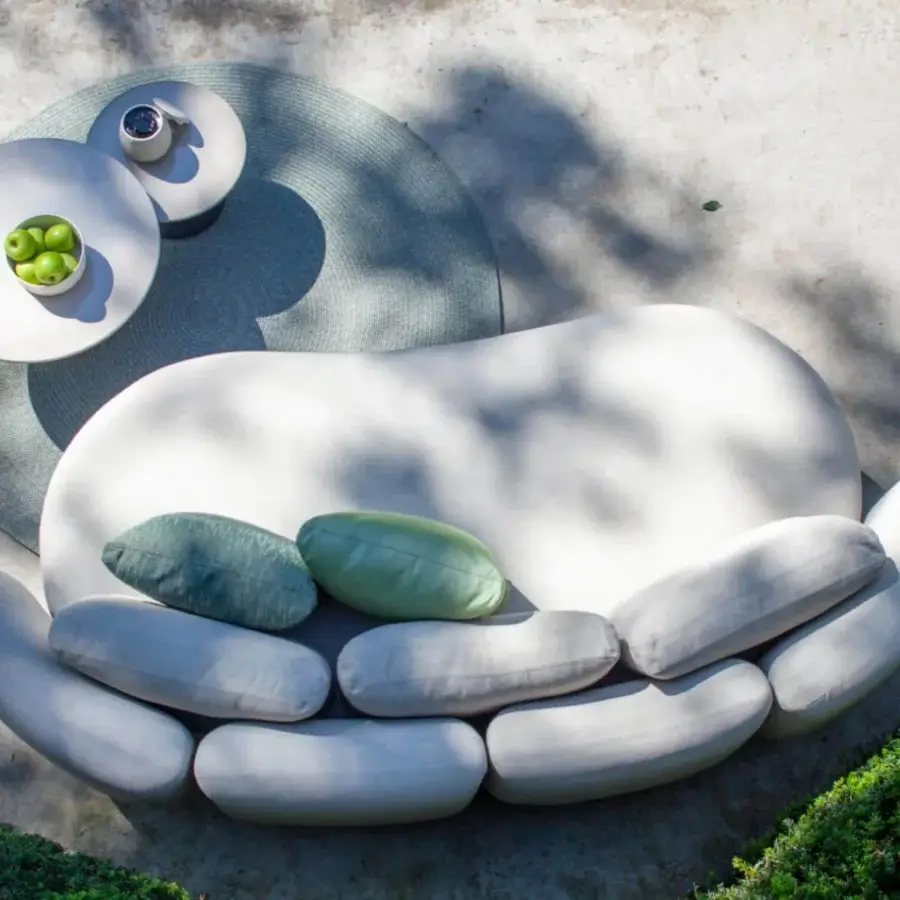 Exceptional Royal Botania Organix Lounge sofa with organically shaped seating, white upholstery, and verdant green cylindrical cushions
