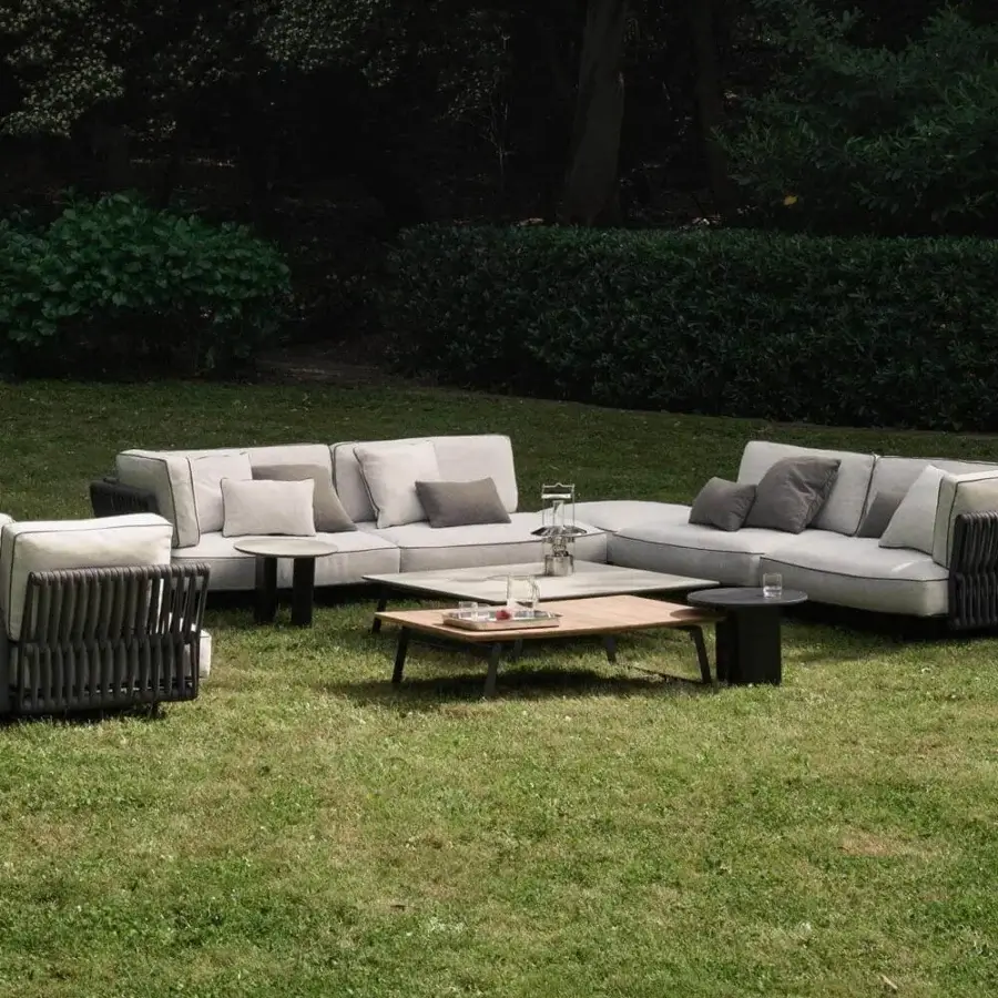Stylish Potocco Soul sectional with interweaving backrest and armrests in dark material, complemented by light gray cushions and coordinating pillows