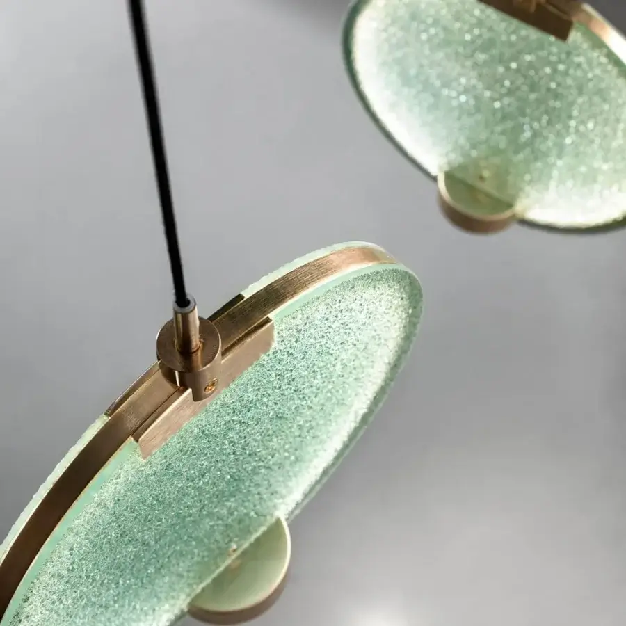 Distinguished Masiero Horo suspension lamp with a refined green glass diffuser and brushed brass metal structure