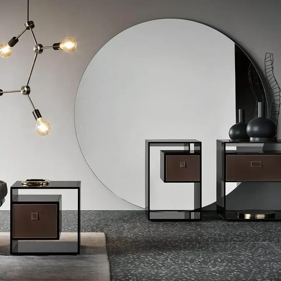 Elegant Tonelli Design Liber console with smoked glass structure and dark leather drawer against a mirror base