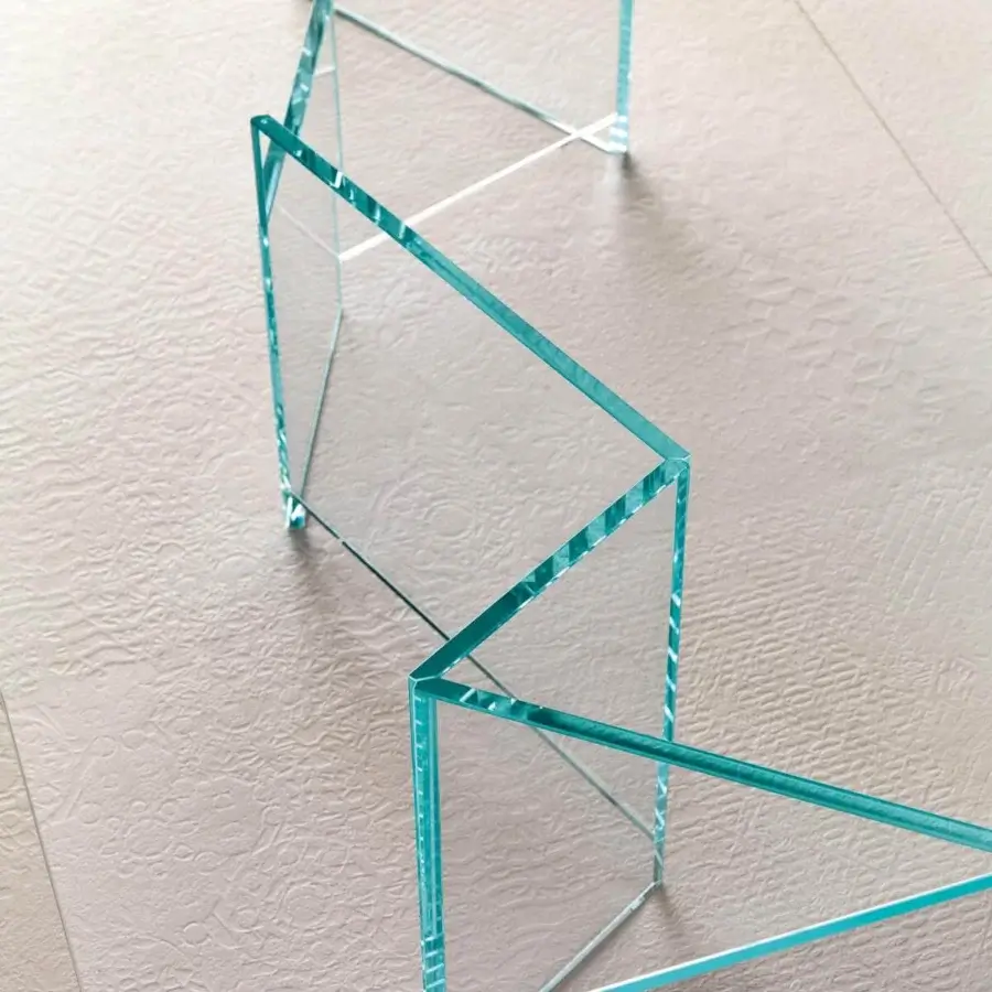 Captivating Tonelli Design Metropolis table with interconnected extra-clear glass slabs and a smooth blue-green tint