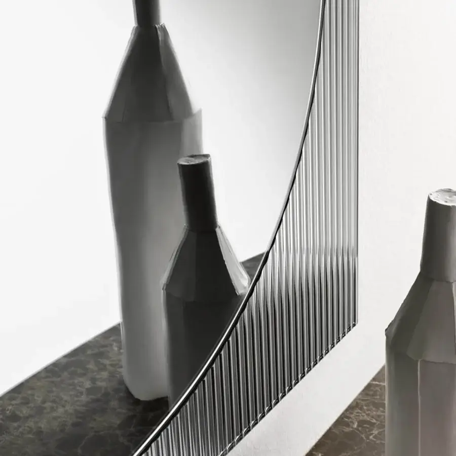 Distinguished Tonelli Design Bands mirror with reeded glass creating depth and texture in a glossy metal frame